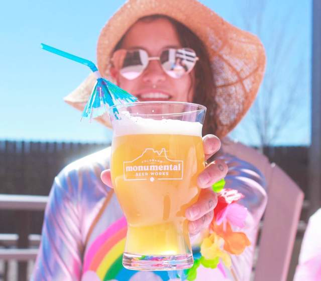 Person holding a Monumental Beer Works Beer