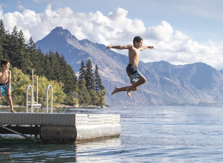 Boy jumping into Lake Whakatipu