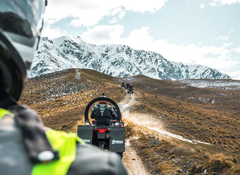 Quad biking on a dirt track at the top of a mountain
