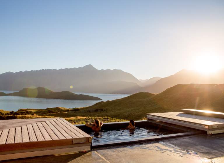 Two women relaxing in the outdoor spa at Aro Ha Wellness Retreat