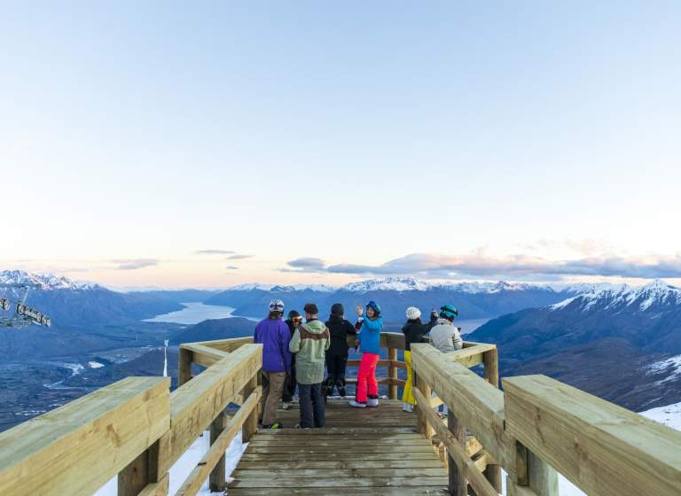 Group of people sightseeing at viewpoint atop of a mountain
