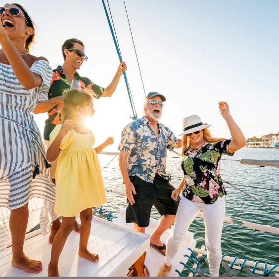 A family celebrating and partying on a boat on off the bay shore on South Padre Island