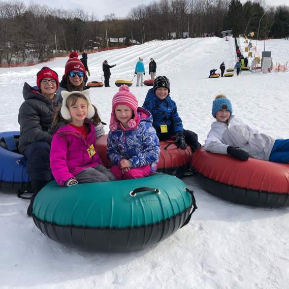 Kids snowtubing in winter