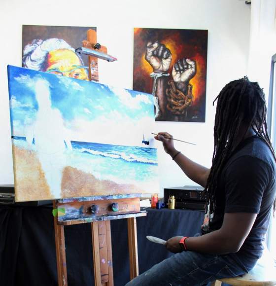 artist painting a canvas in a gallery