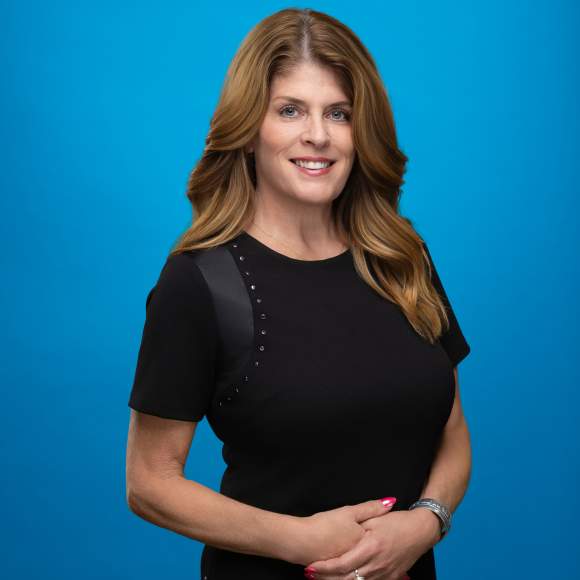 Carrie Thiel's headshot on blue background
