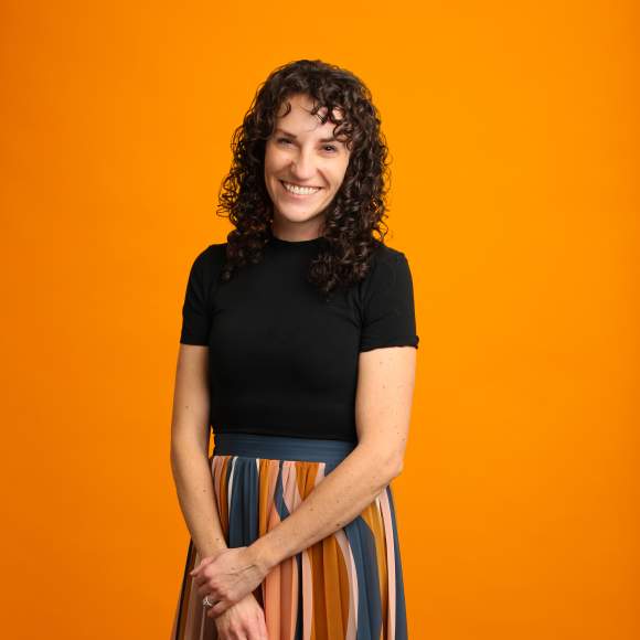 Katie Baker headshot on orange background