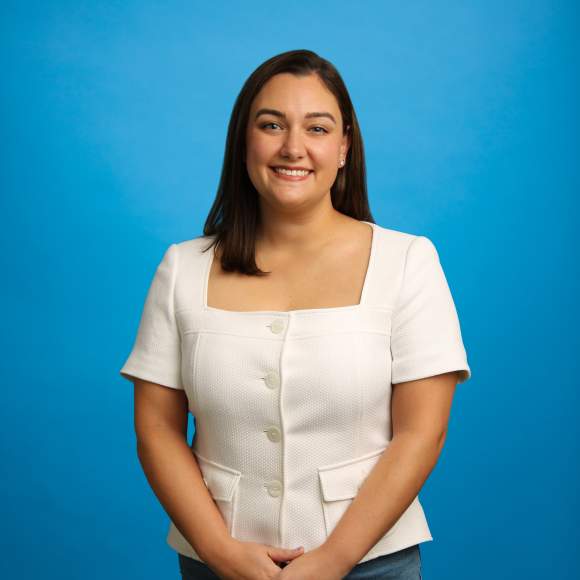 Amanda Kisabeth headshot on blue background