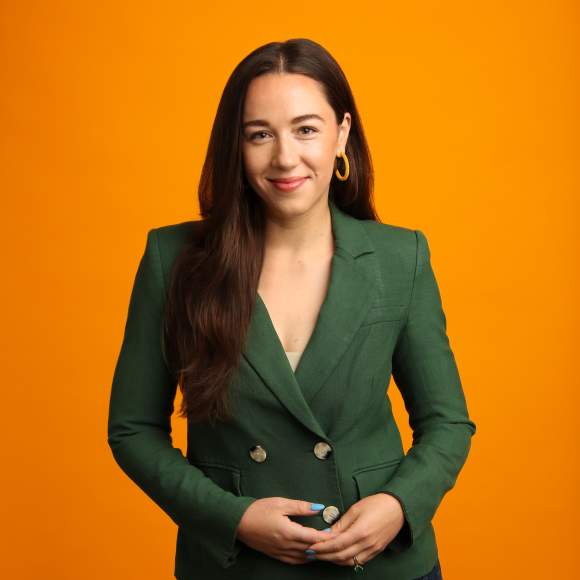 Olivia Karp's headshot on orange background