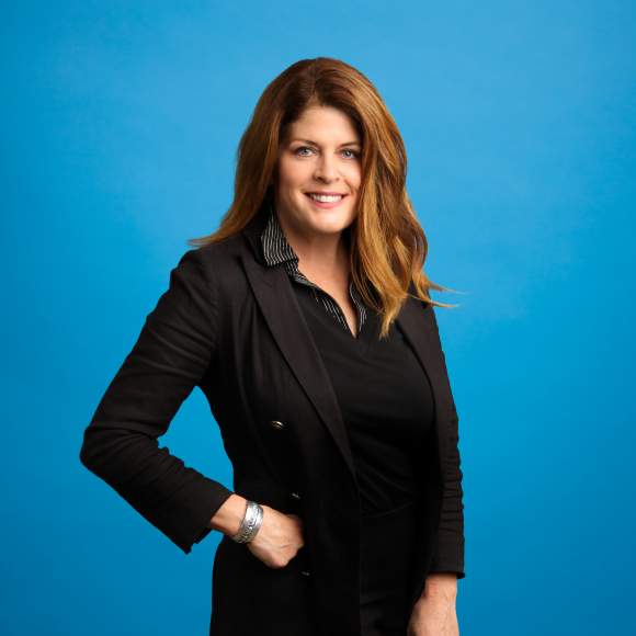 Carrie Thiel headshot on blue background