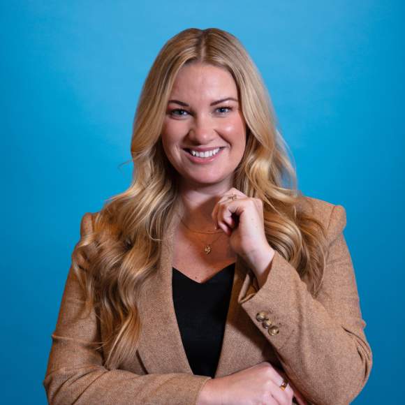 Sara Blatnik headshot on blue background
