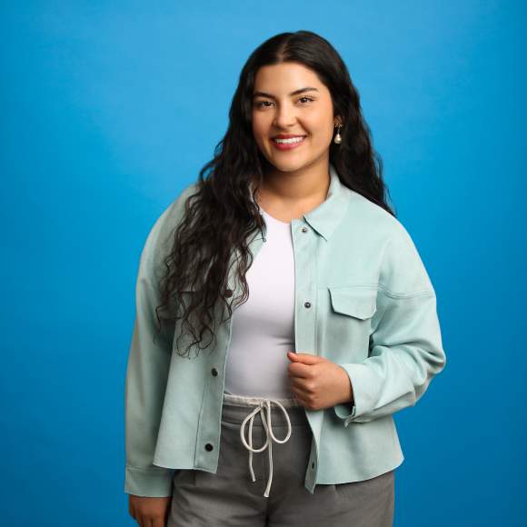 Dakota Brown headshot on blue background