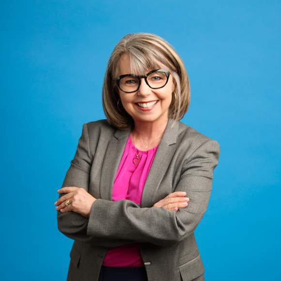 Robin Davis headshot on blue background