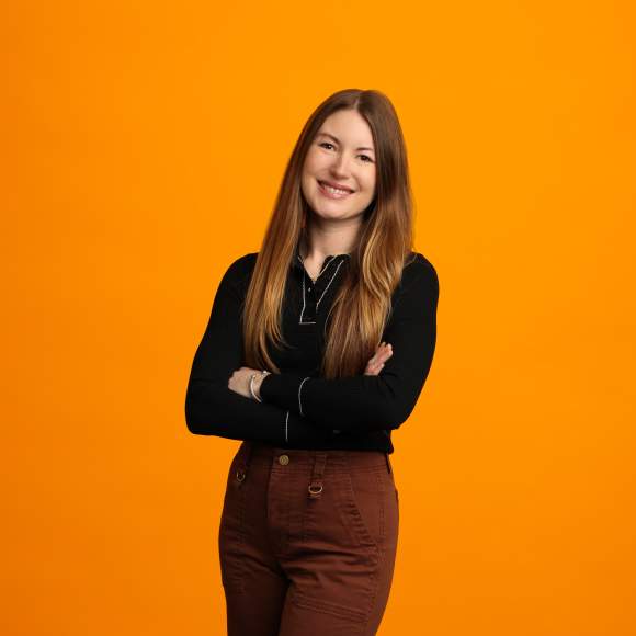 Brianna Bolt headshot on orange background