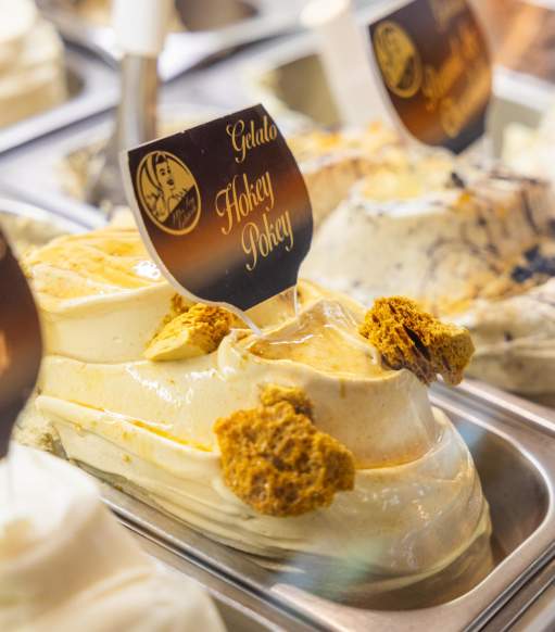 Close up of gelato in a shop with a sign reading Hokey Pokey