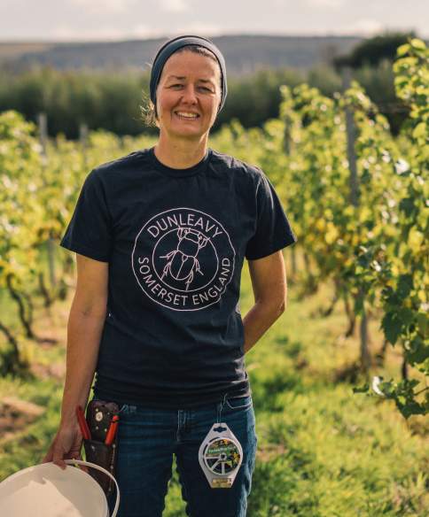 A woman standing in a vineyard in North Somerset near Bristol - credit GOOD Stories in Food