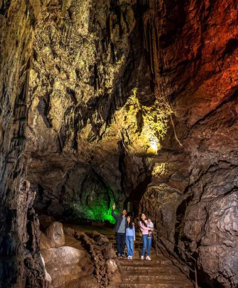 A family in a cave at Wookey Hole near Bristol - credit Wookey Hole