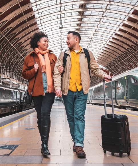 2 people with luggage on the platform at Paddington Train Station - Credit Great Western Railway