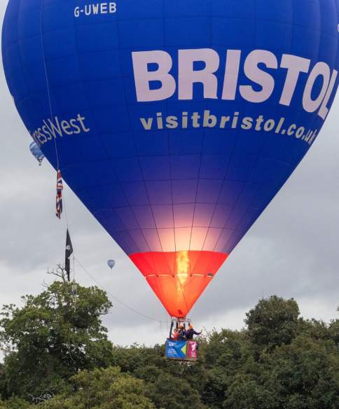A group of balloons lifting off in a mass ascent at Bristol International Balloon Fiesta 2025