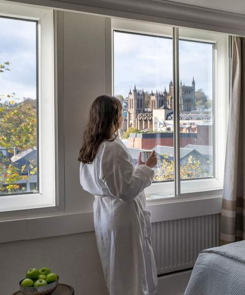 a view of a woman looking out the window of Bristol Cathedral and The Harbourside at Leonardo Royal Hotel Bristol