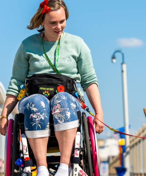 A wheelchair user and their dog on the Grand Pier at Weston-super-Mare near Bristol - credit The Grand Pier