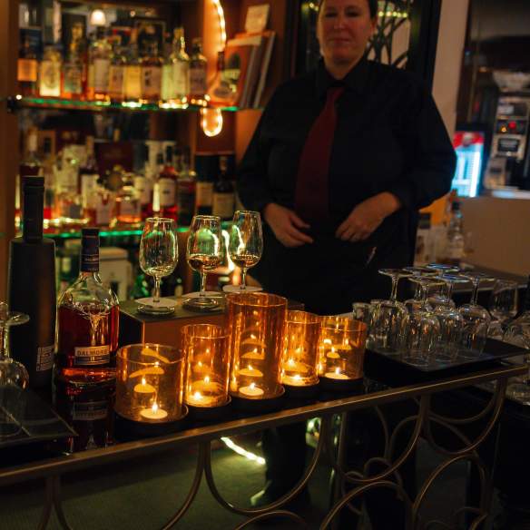 A bar tender showing off their drinks.