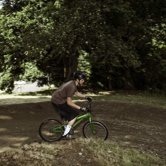 A person on a mountain bike riding down a dirt trail.