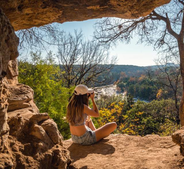 woman sitting on overlook at greenbelt in Austin Texas