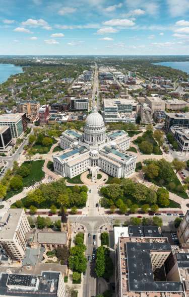 An aerial view of the State Capitol with the isthmus stretching behind it.