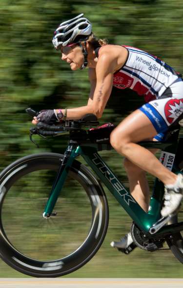 A woman rides her bike during the IRONMAN competition