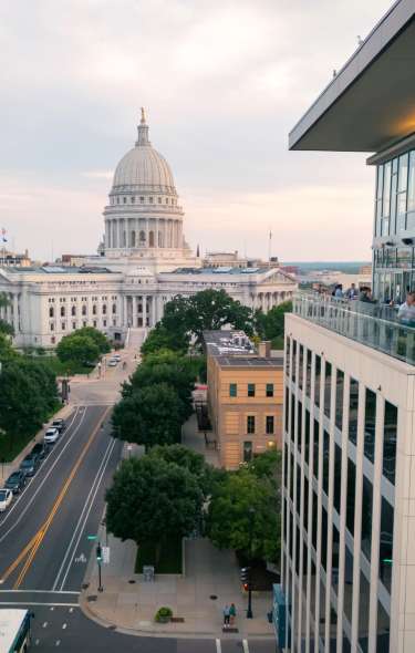 Image of the Capitol Building in the background and a rooftop balcony in the foreground