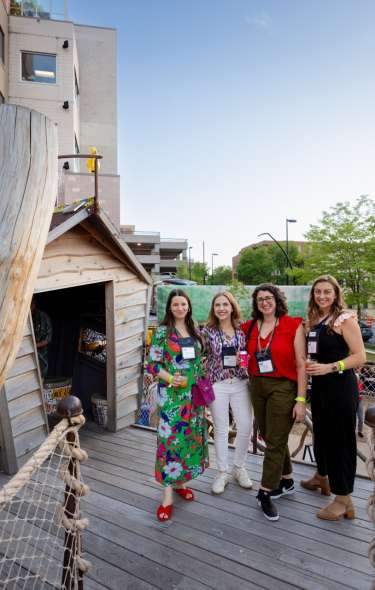 Four conference attendees standing on outdoor play area of the Madison Children's Museum