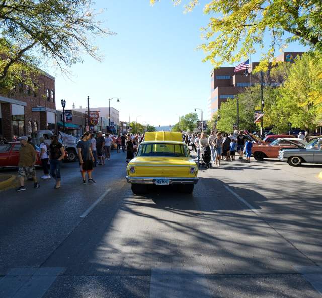 classic cars and people walking the streets of downtown rapid city during the cruiser car show event