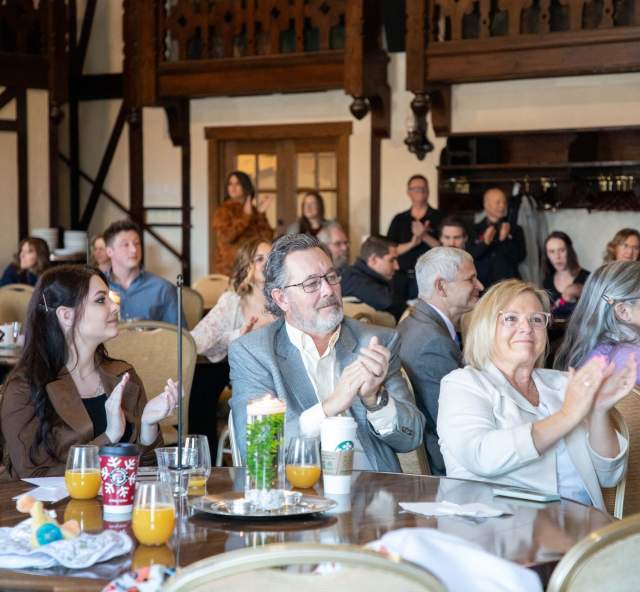 Group applauding at a businesses event in Rapid City, SD