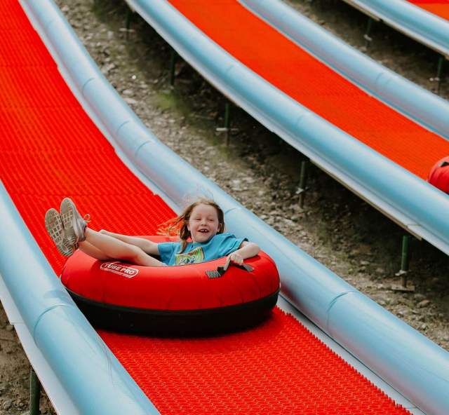 Kids enjoying the tubing hill at rushmore tramway adventures