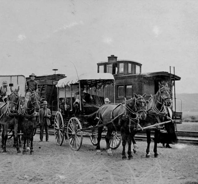 Historic photo of carriages in front of train in Granby