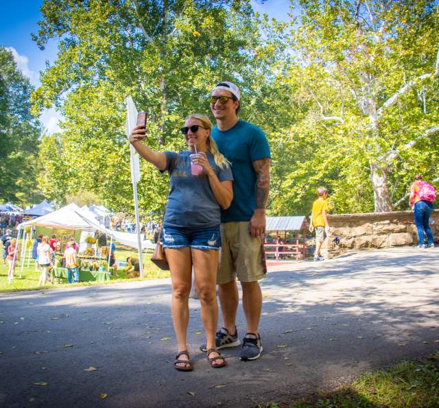 A couple taking a selfie at the Covered Bridge Festival