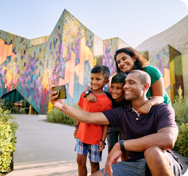A family poses for a photo during a visit to the Museum at Prairiefire in Overland Park