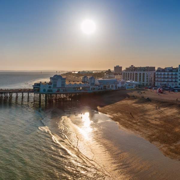 Photograph by Shaun Roster showing the Southsea Beach and South Parade Pier as the sun begins to set behind it.