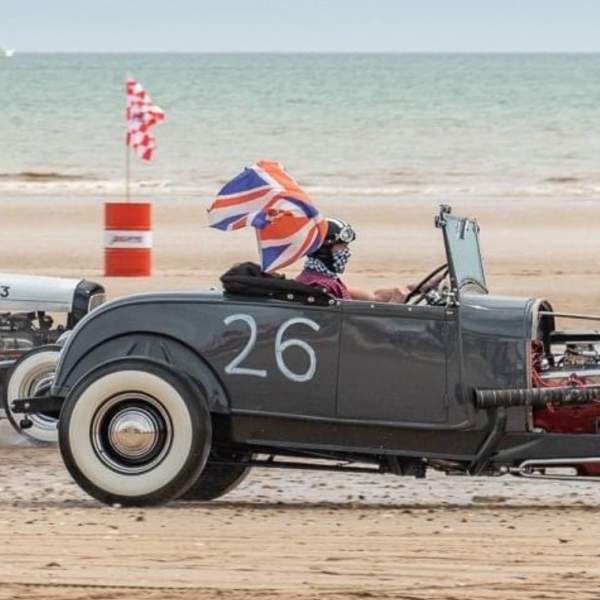 A vintage car roaring across Bridlington's South Beach in East Yorkshire as part of the Race the Waves event