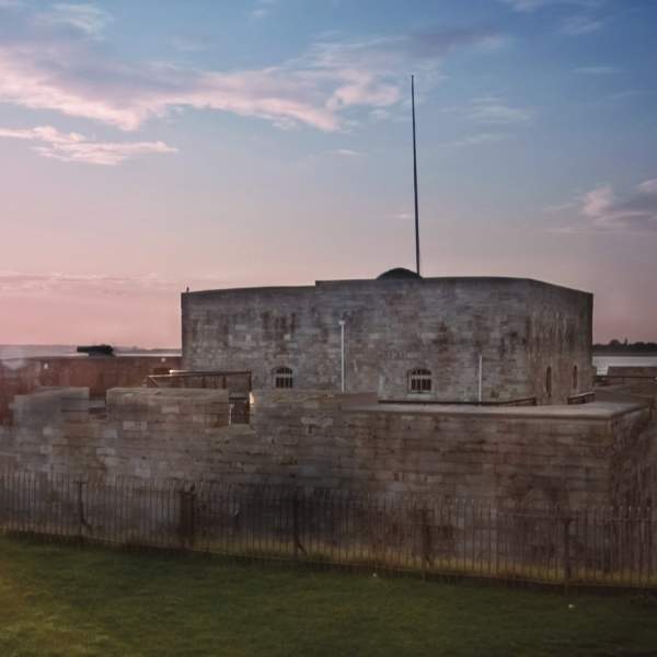 Photograph showing Southsea Castle with a pink-hued sunset behind