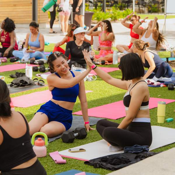 Several people in an AltSocial yoga class at Boxi Park Lake Nona