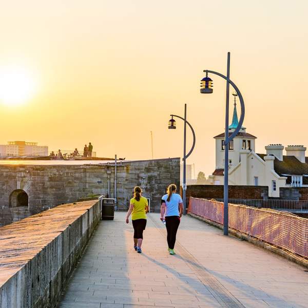 Photograph of two people walking on the fortifications of Old Portsmouth