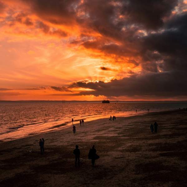 Photograph showing a fiery red sky over the Southsea Beach at dusk