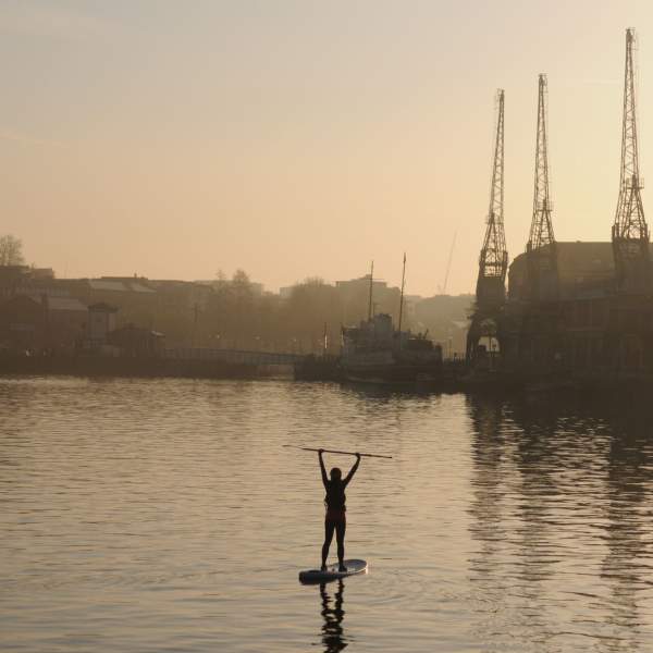 someone SUPing at Sunset