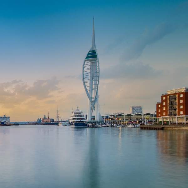 Wide-angle photograph showing Spinnaker Tower and very still waters of Portsmouth Harbour