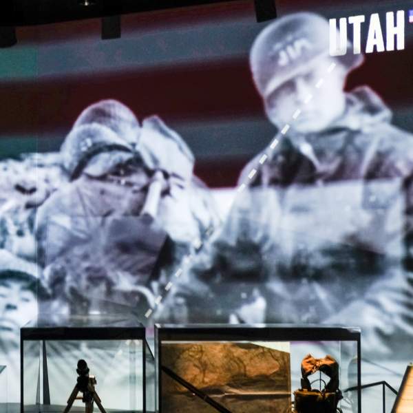 Photograph of two visitors to The D-Day Story looking at the audio-visual displays