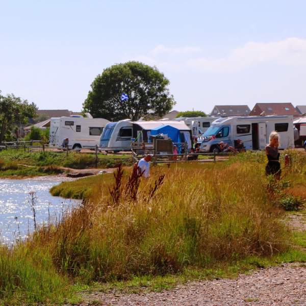 People enjoying the waterside location of Fishery Creek Caravan Park near Portsmouth