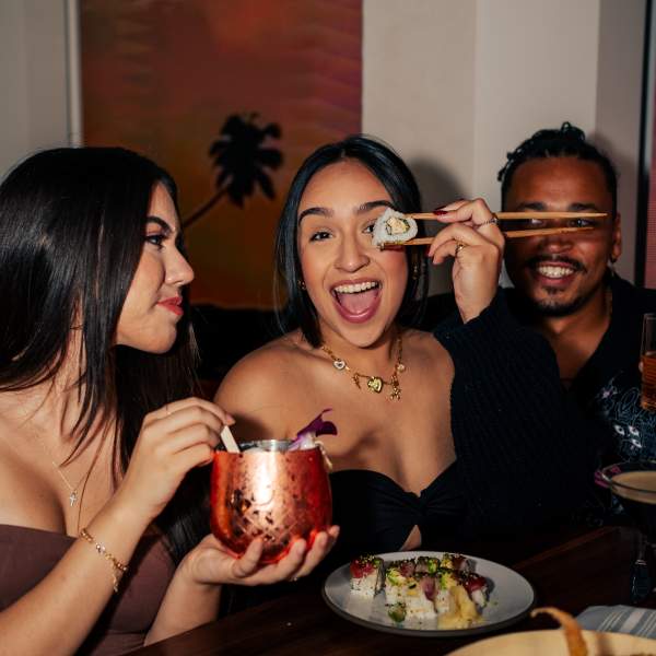 Friends eating together at Palm Tree Club