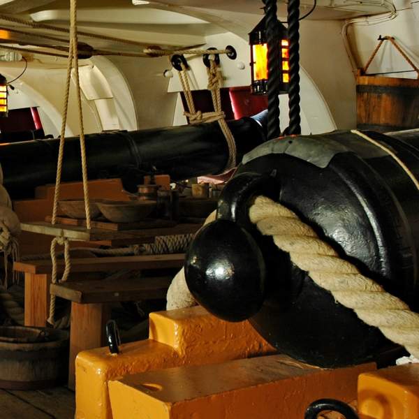 A photograph showing the gun deck and cannons inside HMS Victory