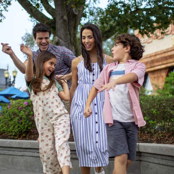 A family dancing in a theme park.